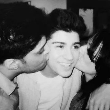 Zayn and his father, Yaser Malik, and his mother, Trisha Malik, took a picture as they kissed Zayn's cheeks.
